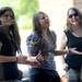 Friends, from left,  Kylee (no last name given), 16, of Bloomfield, Hailey Broderick, 14, of Holly and Bia Cassano, 15, Pontiac dance as Alejandra O'Leary and her band performs at the Summer Concert Series on the porch at AnnArbor.com. Melanie Maxwell I AnnArbor.com
